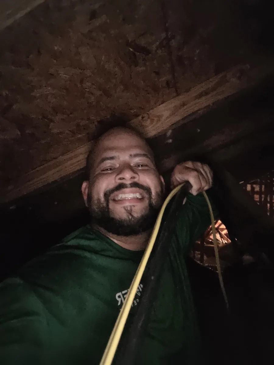 Mister Safety electrician Hector pulling wiring for a dedicated circuit in a home’s attic