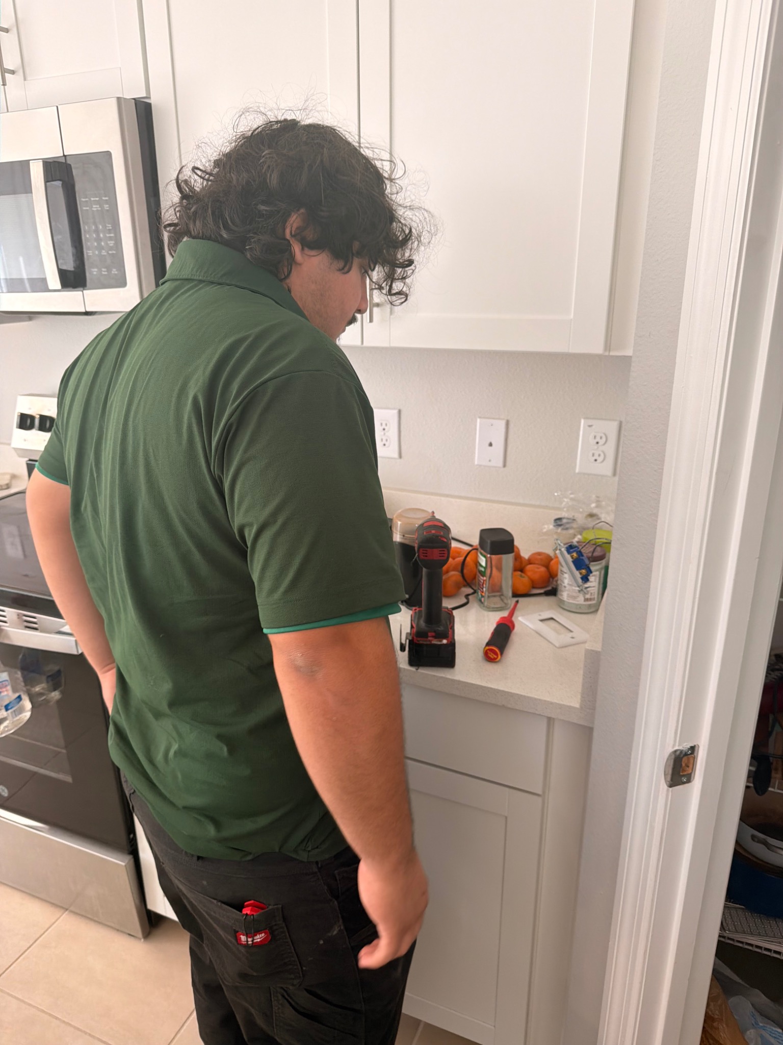 Romeo in the Mister Safety uniform during a kitchen electrical service visit