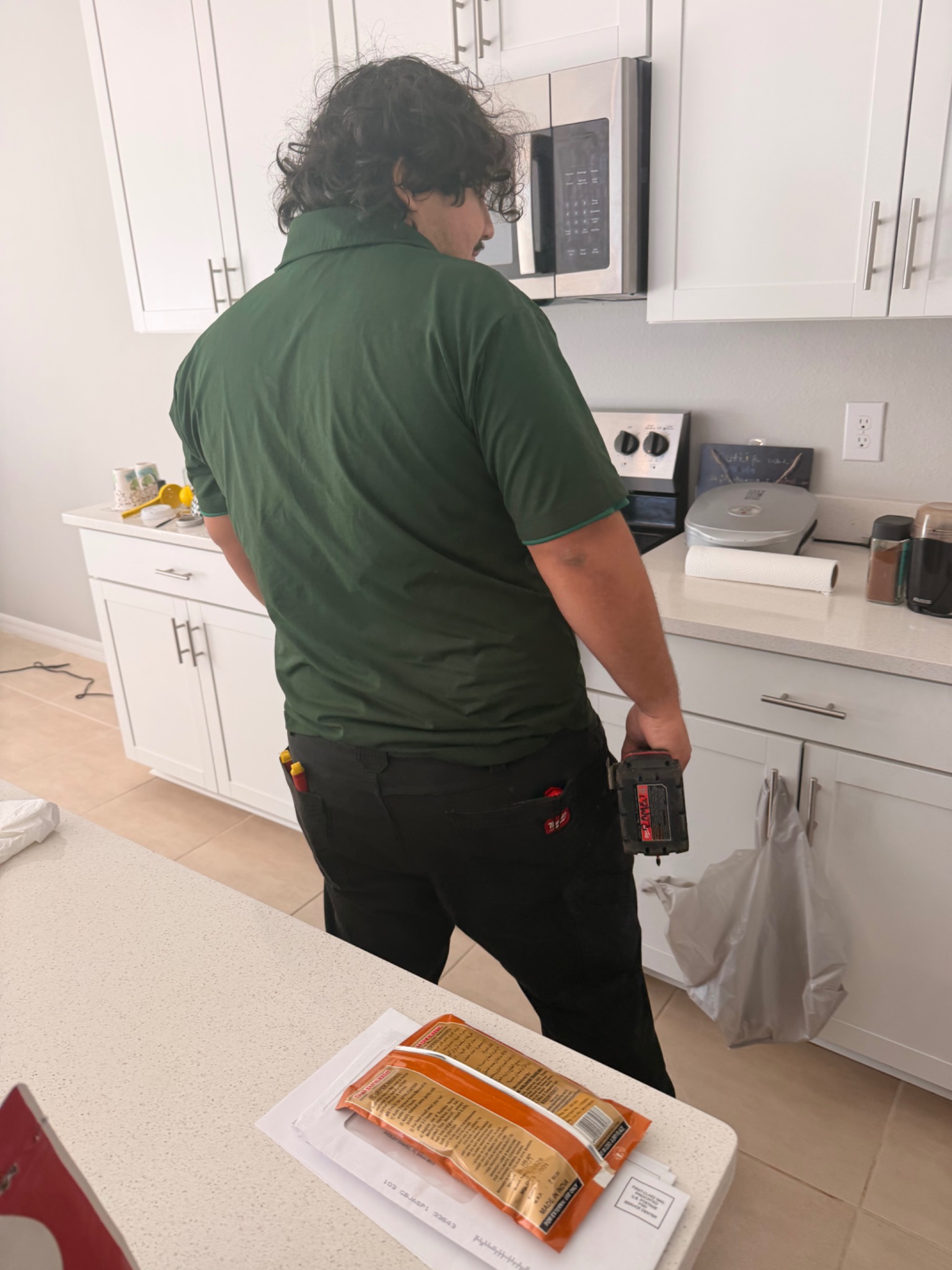 Romeo carrying tools during a Mister Safety kitchen service visit